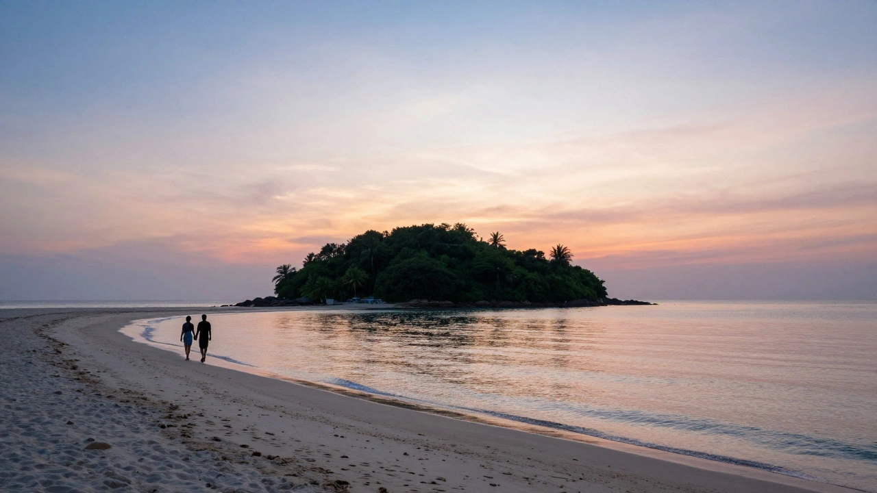 Couple walking on sandbar connecting island at Betalbatim Beach during sunset