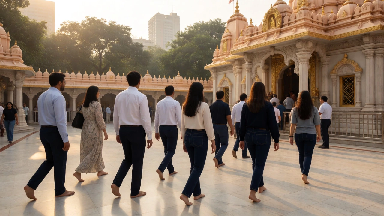 People in modest dark jeans and casual wear walking barefoot in a sunny temple courtyard.